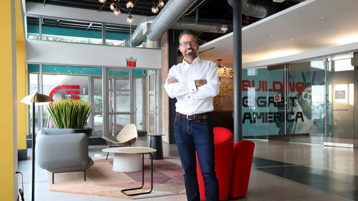 David Ditchman in the lobby of the Frontier Communications headquarters in Uptown Dallas, exposed brick and ductwork behind him